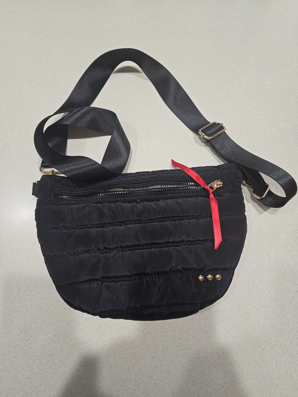 Black Quilted Crossbody Bag with Red Ribbon Accent